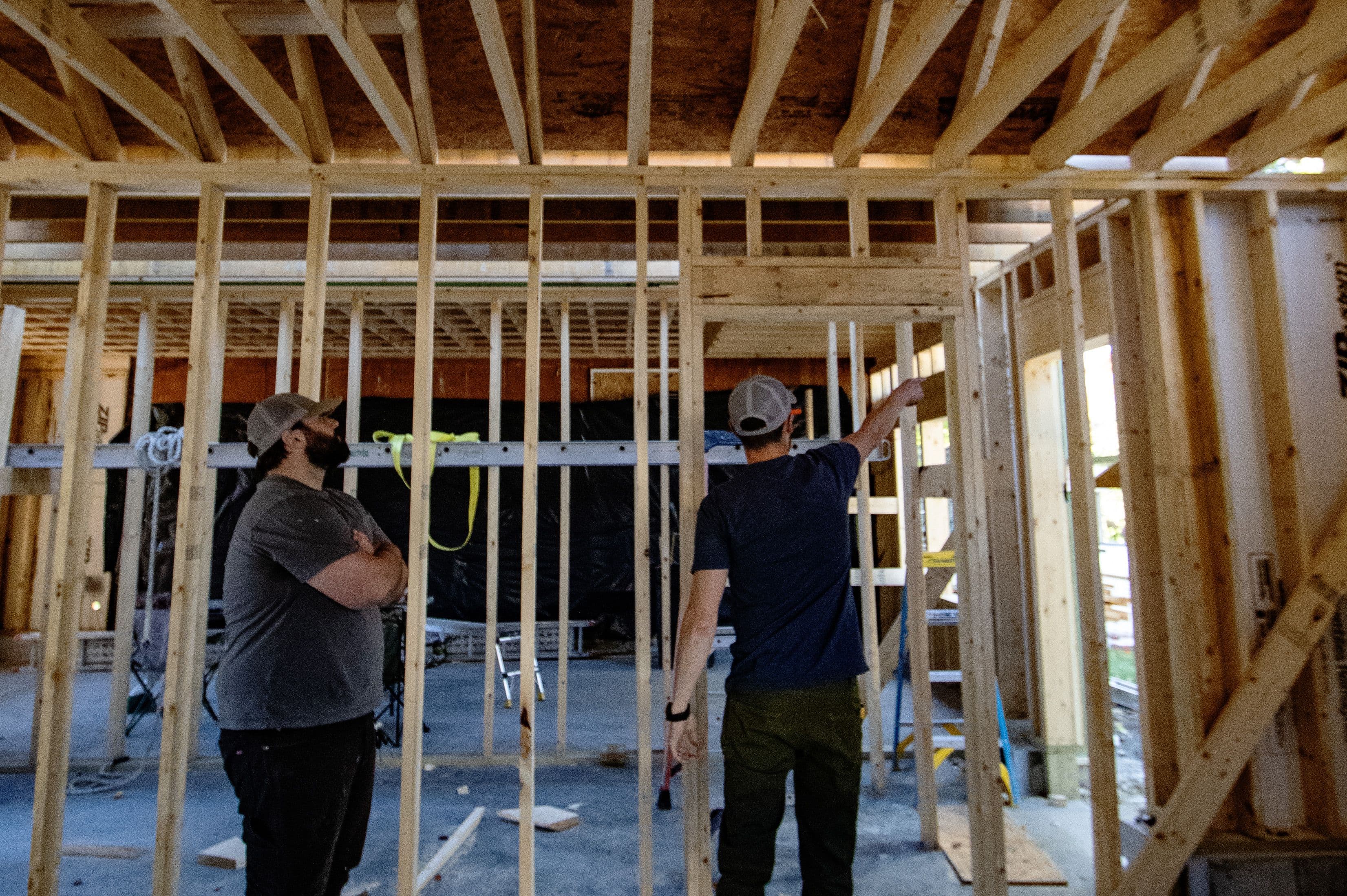 Project manager Jake Coughlin and Orion co-founder Reece Teixeira reviewing project details at a job site.